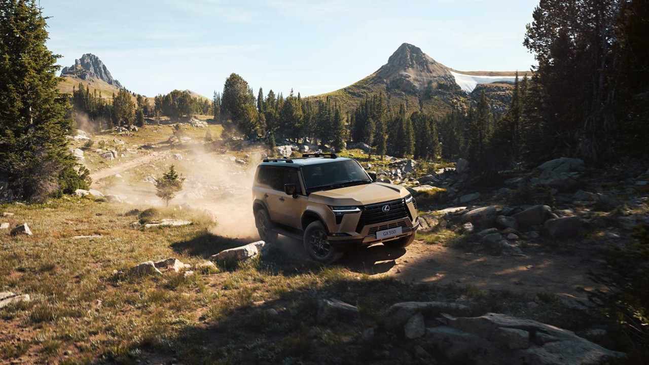 The Lexus GX driving in a forest